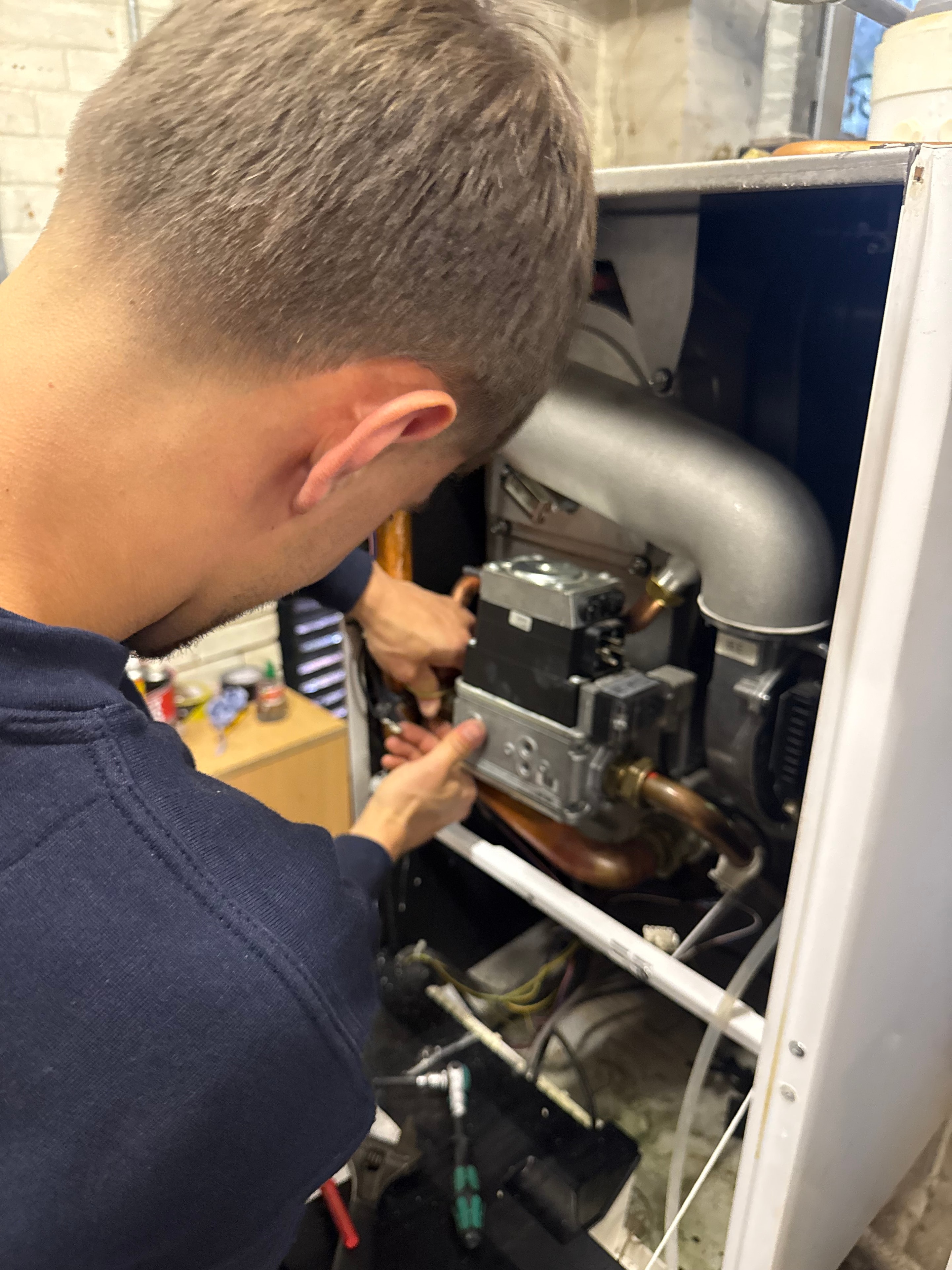 Engineer repairing a boiler heat exchanger