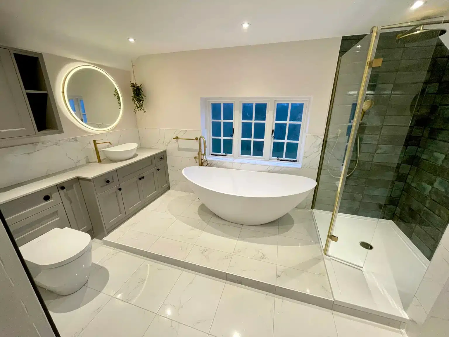 Luxury bathroom with freestanding bath, walk-in shower and marble tiles
